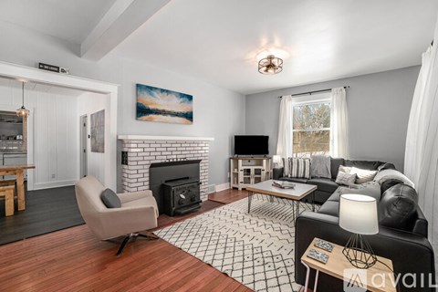 A living room with a fireplace and a painting on the wall.