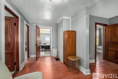A room with a wooden floor and a white ceiling with a skylight.