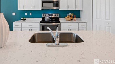 A kitchen with a sink and a stove.
