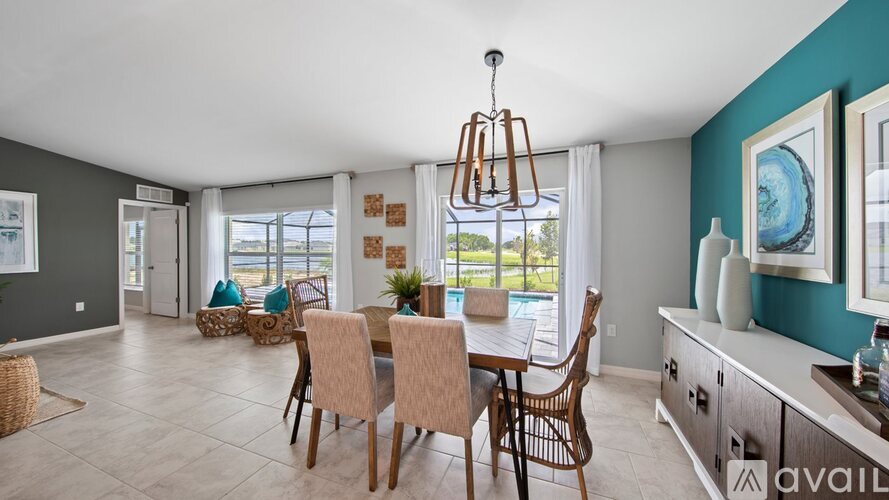 A dining room with a table set for six and a chandelier hanging from the ceiling.