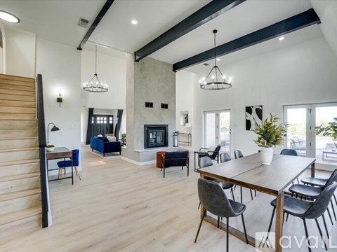 A modern dining room with a wooden table and chairs.