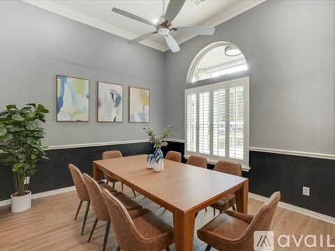 A dining room with a wooden table and chairs.