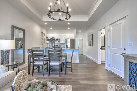 A dining room with a table set for six.