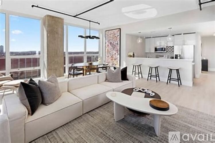 A modern living room with a large window and a view of the city.