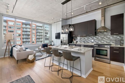 A modern kitchen with a dining table and chairs is available for rent.