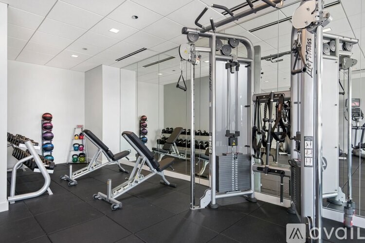 A gym with a variety of equipment including weights and machines.