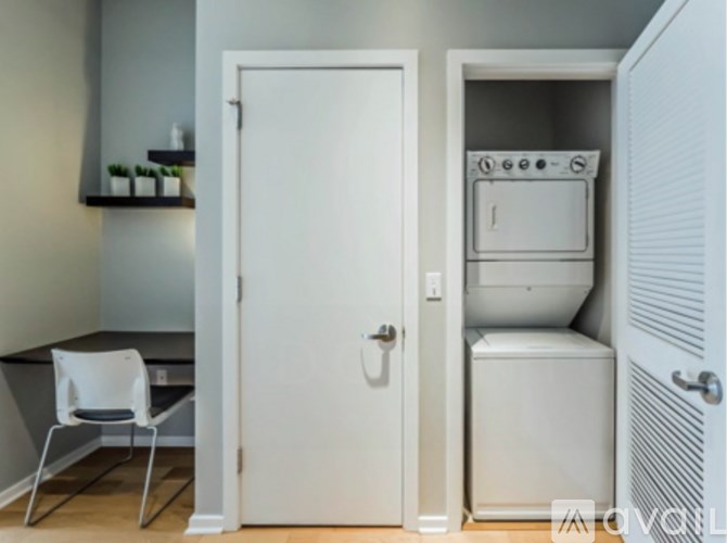 A white chair is placed in front of a white door.