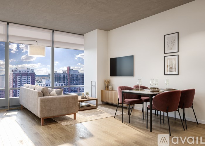 A living room with a couch, chairs, and a television.