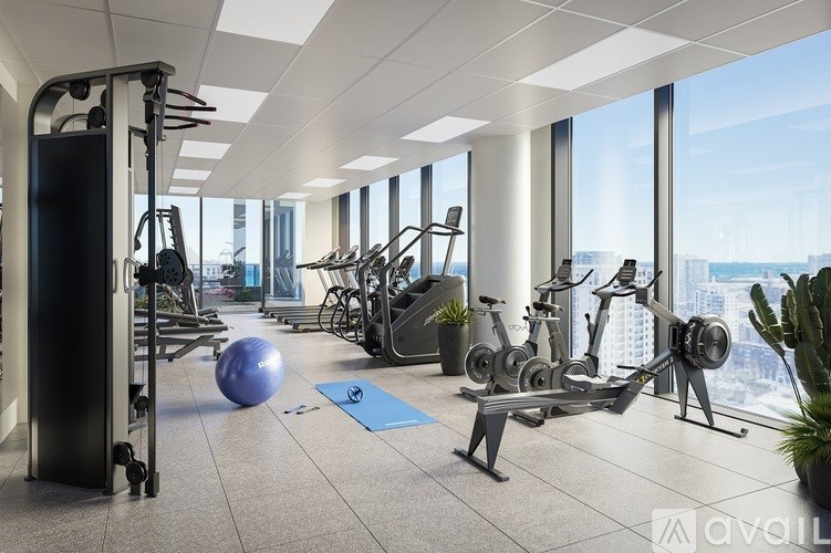 A gym with a view of the city outside the windows.