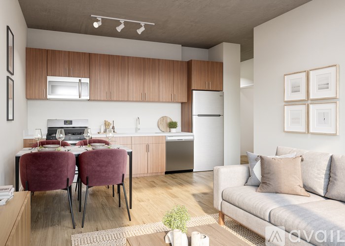 A modern kitchen with a dining table set for two.