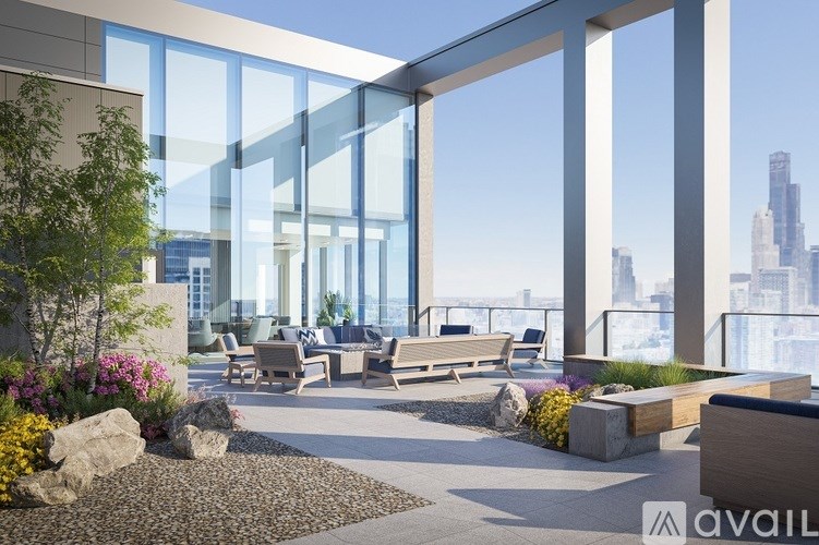 A modern outdoor seating area with a view of the city skyline.