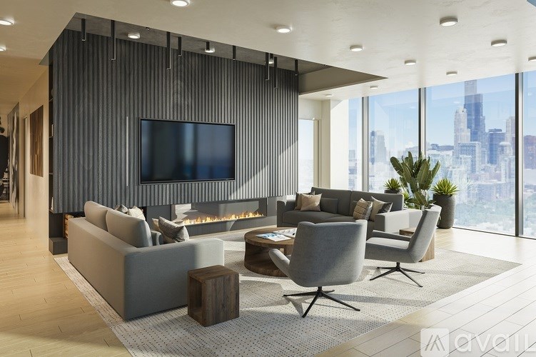 A modern living room with a grey sofa set and a flat screen TV mounted on the wall.