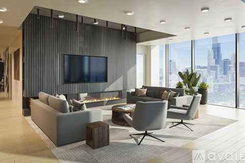 A modern living room with a grey sofa set and a flat screen TV mounted on the wall.