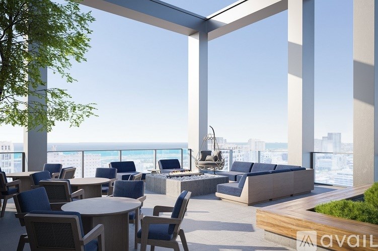 A patio with a table and chairs overlooking a cityscape.