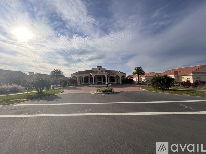 A sunny day at the entrance of a building with a sign that reads "AVAIL".