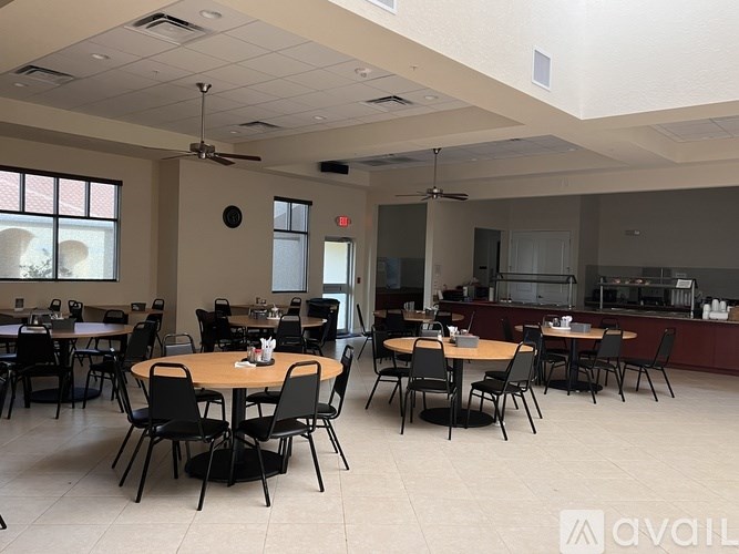 A spacious room with tables and chairs is available for use.