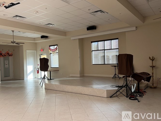 A room with a white floor and a ceiling fan.