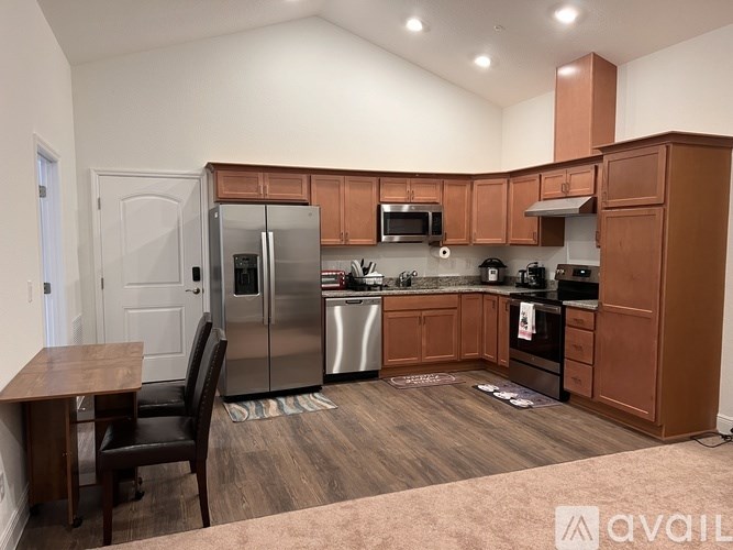 A kitchen with wooden cabinets and stainless steel appliances.
