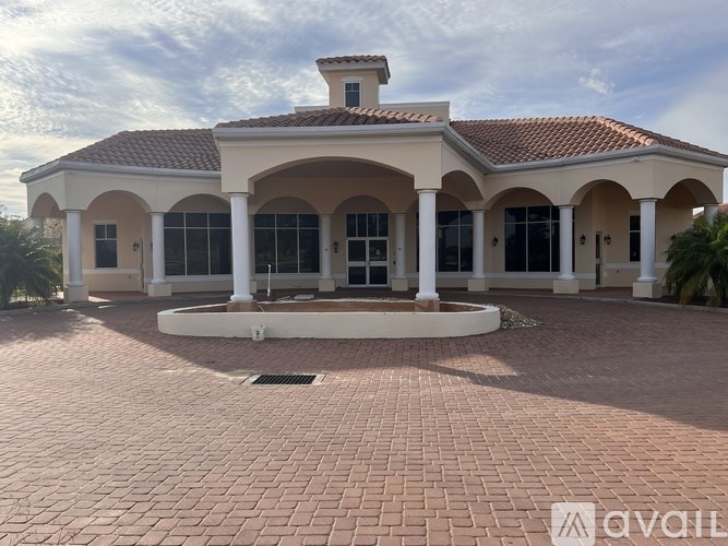 A house with a red tiled roof and a covered patio area.
