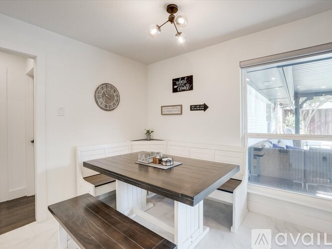 A dining room with a wooden table and benches.