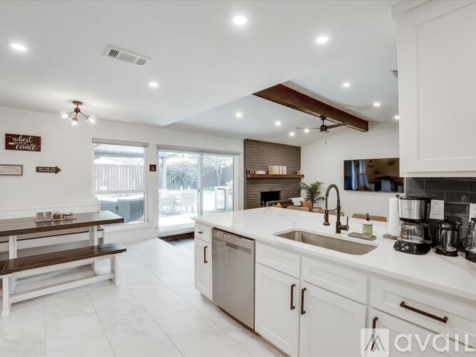 A modern kitchen with white cabinets and a large island.