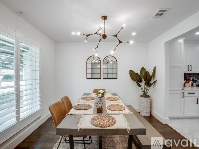 A dining room with a table set for a meal.