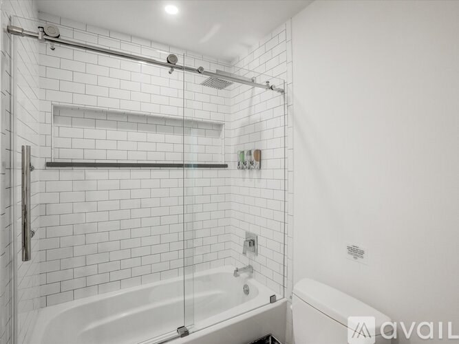 A white bathroom with a tub and a shower.
