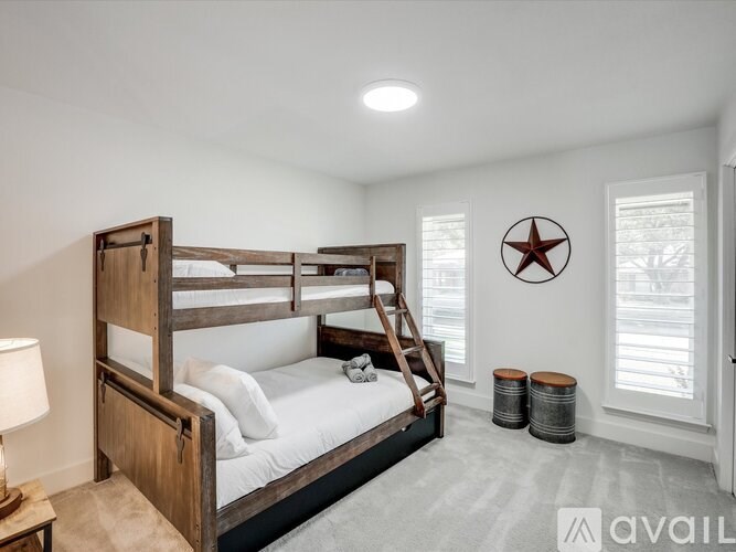 A bedroom with a bunk bed and a star decoration on the wall.