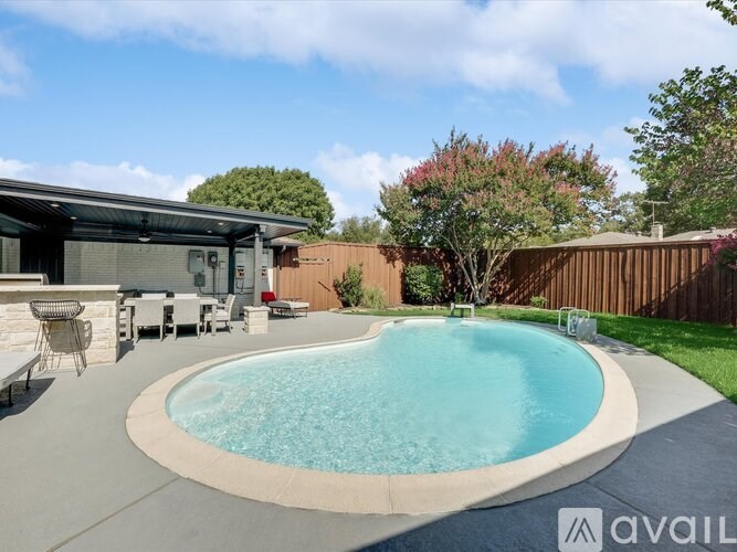 A small pool in a backyard with a patio and chairs.