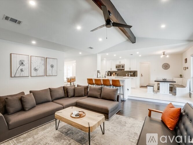 A living room with a brown sofa and a wooden coffee table.