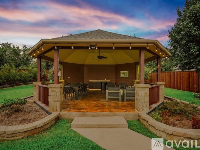 A covered patio area with a table and chairs is available for rent.