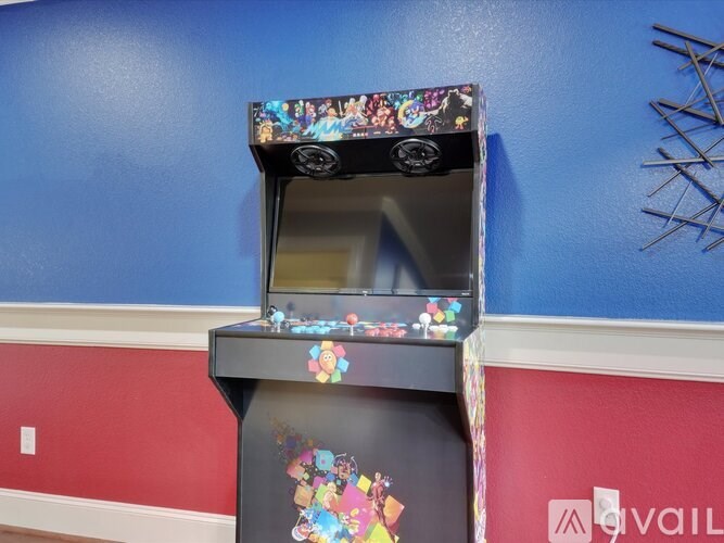 A small arcade machine with a colorful design on the front.
