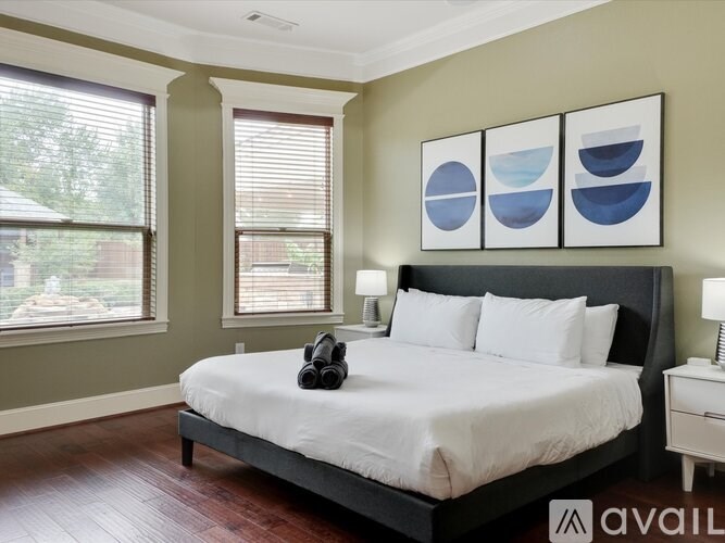 A bedroom with a large bed and a pair of headphones on the bed.