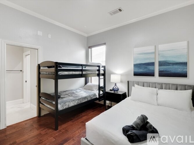 A bedroom with a bunk bed and a single bed.