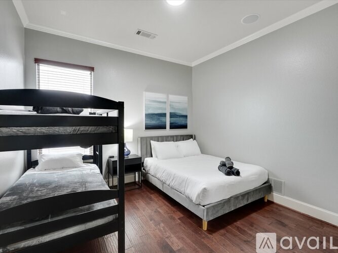 A bedroom with a bunk bed and a single bed.