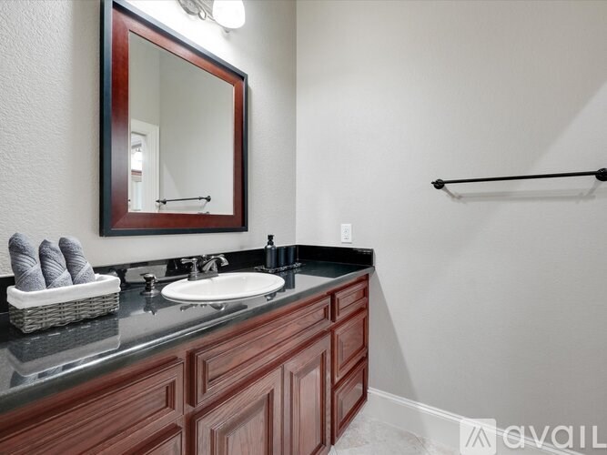 A bathroom with a sink and a mirror.