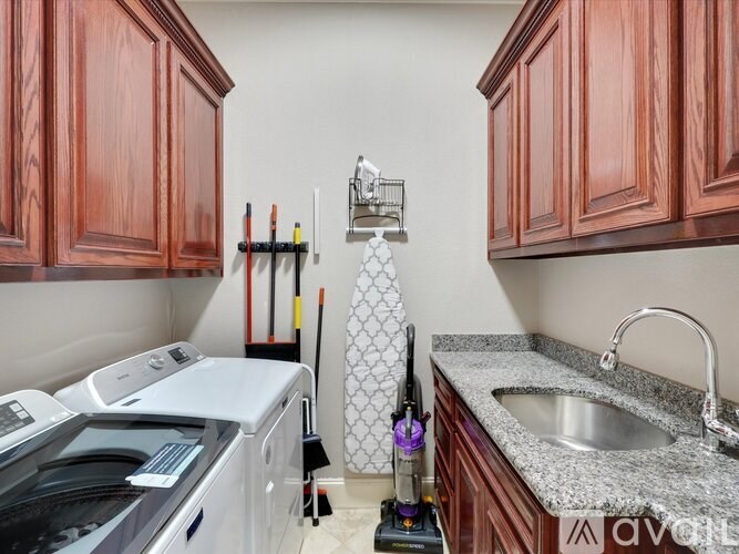 A kitchen with wooden cabinets and a white dishwasher.