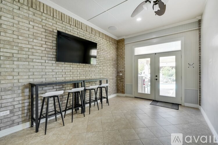 A room with a brick wall and a bar area.