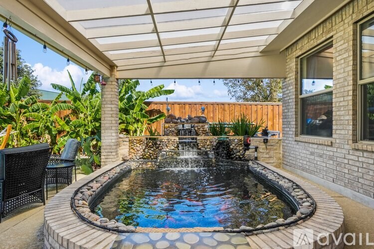 A patio with a pool and a table.