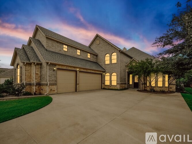 A large house with a driveway in front of it.