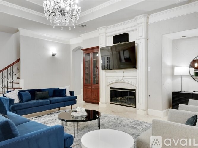 A living room with a blue sofa and a fireplace.