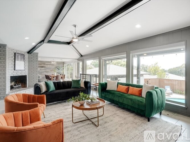 A living room with a fireplace, two sofas, and a coffee table.