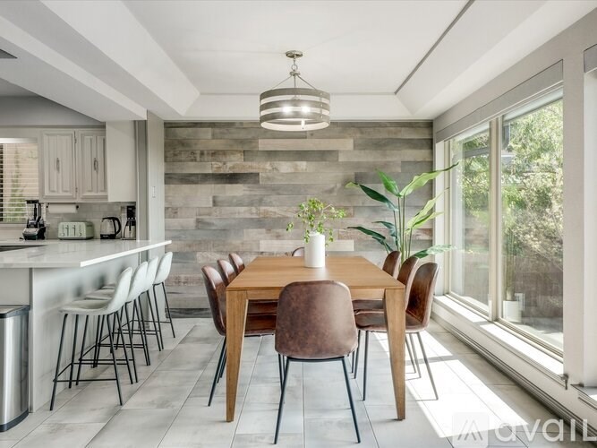 A modern kitchen with a dining table and chairs.