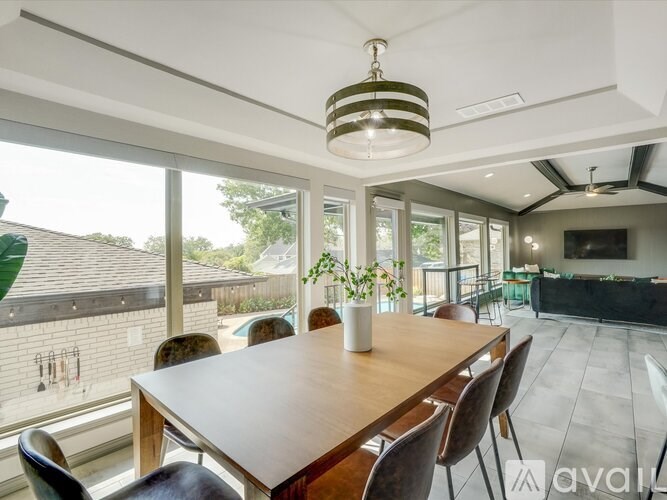 A dining room with a wooden table and chairs.