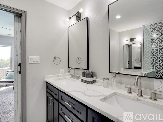 A bathroom with a white sink and a mirror above it.