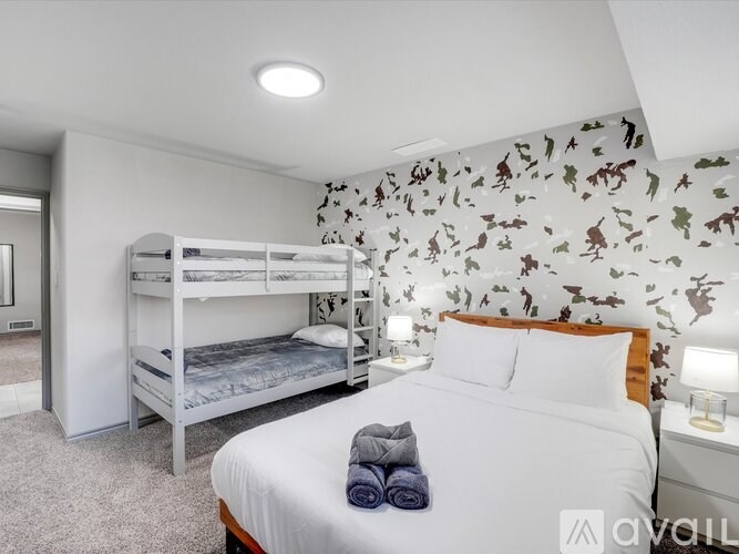 A bedroom with a large bed and bunk beds.