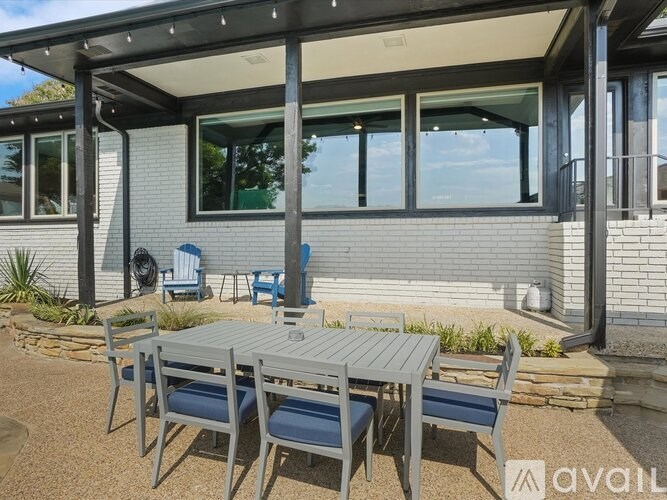 A patio with a table and chairs is available for use.