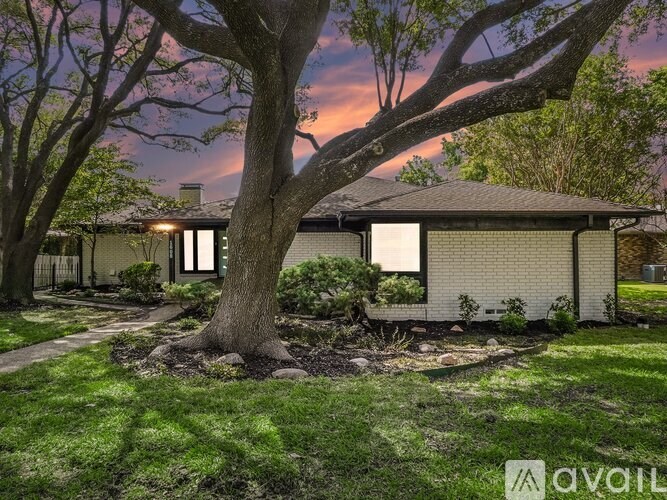 A house with a tree in front of it.
