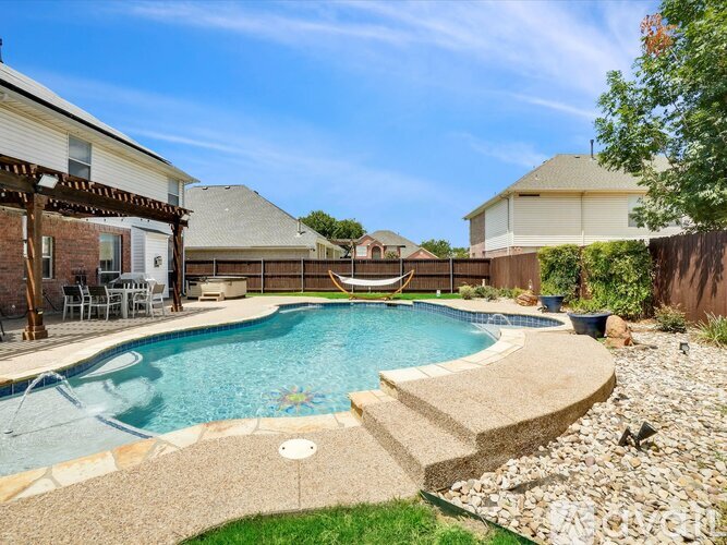 A backyard with a pool and patio furniture.