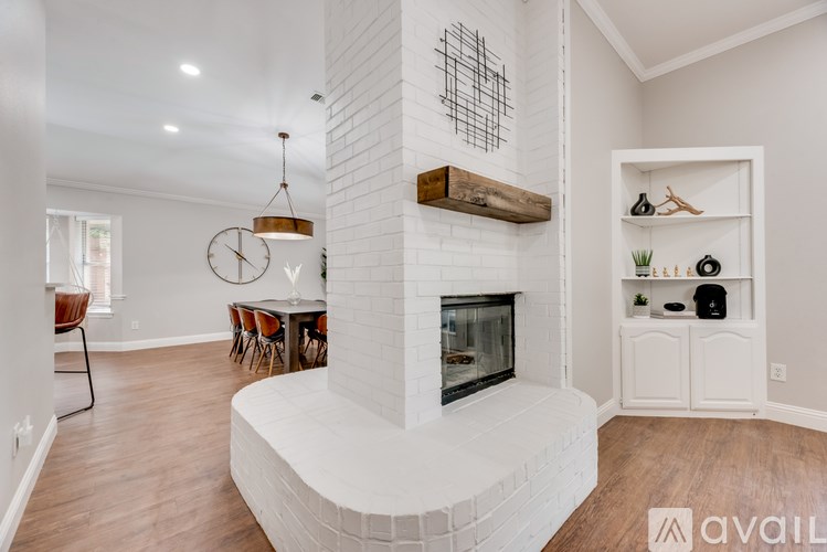 A living room with a fireplace and a dining table.